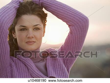 Close up of woman with sun setting in background View Large Photo Image Stock Image - Close up of woman with sun setting in background. Fotosearch