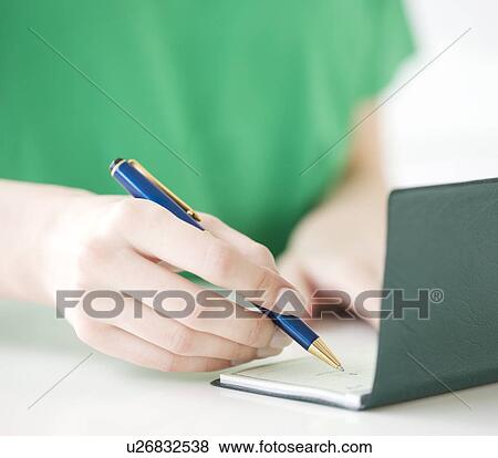 Close up of woman writing check View Large Photo Image Stock Photo - Close up of woman writing check. Fotosearch