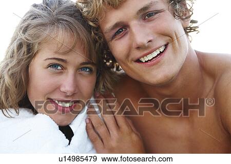 Close up of young couple hugging View Large Photo Image Stock Photo - Close up of young couple hugging. Fotosearch