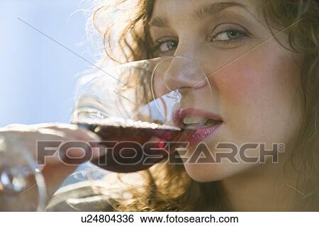 Close up portrait of woman drinking red wine View Large Photo Image Stock Photograph - Close up portrait of woman drinking red wine. Fotosearch