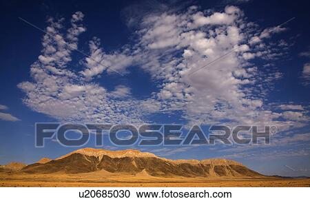 Stock Image - Clouds in blue sky over mountain, Namib Desert, Namibia, Africa. Fotosearch