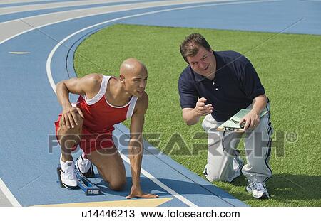 Coach giving runner advise View Large Photo Image Stock Image - Coach giving runner advise. Fotosearch
