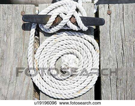 Stock Photograph - Coiled rope and nautical knot. Fotosearch