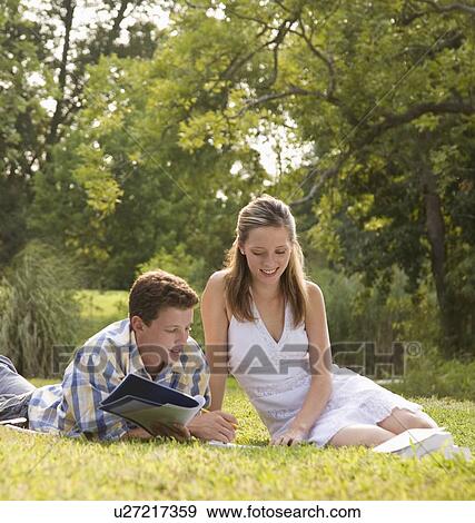 Stock Photo - College students studying in grass. Fotosearch