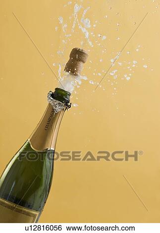 Cork exploding from champagne bottle View Large Photo Image Stock Photograph - Cork exploding from champagne bottle. Fotosearch
