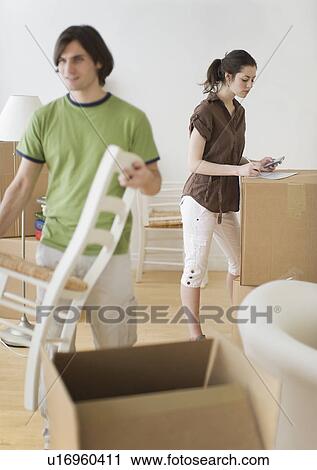 Couple and moving boxes in new home View Large Photo Image Stock Image - Couple and moving boxes in new home. Fotosearch