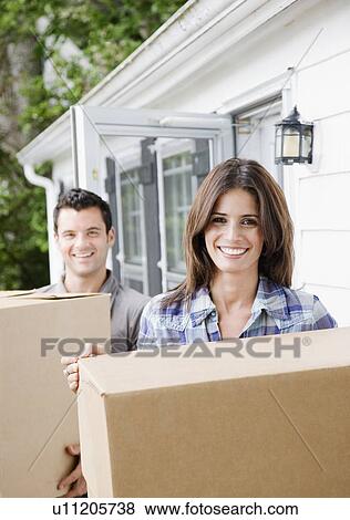 Couple carrying cardboard boxes View Large Photo Image Stock Photo - Couple carrying cardboard boxes. Fotosearch