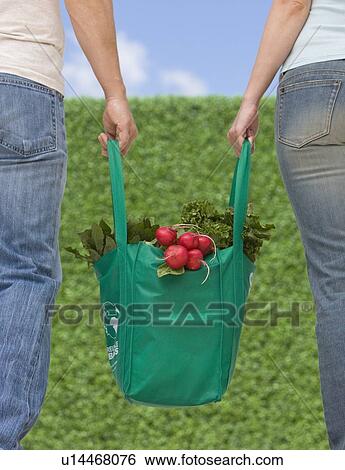 Couple carrying organic produce View Large Photo Image Stock Photograph - Couple carrying organic produce. Fotosearch