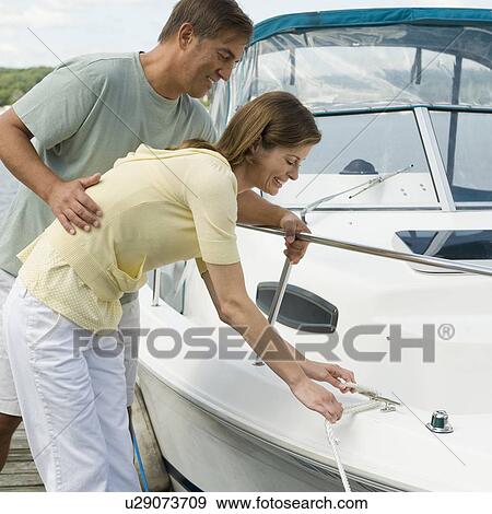Couple docking speed boat View Large Photo Image Stock Photo - Couple docking speed boat. Fotosearch