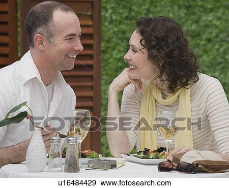 Stock Photo - Couple eating outdoors. Fotosearch