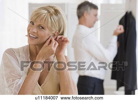 Stock Photo - Couple getting dressed. Fotosearch