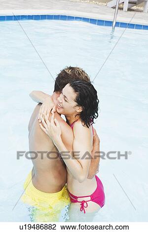 Couple hugging in swimming pool View Large Photo Image Stock Image - Couple hugging in swimming pool. Fotosearch