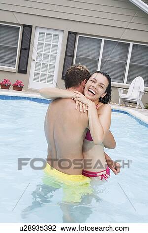 Couple hugging in swimming pool View Large Photo Image Stock Image - Couple hugging in swimming pool. Fotosearch