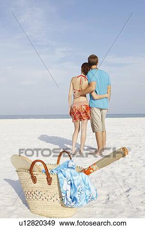 Stock Photo - Couple hugging on beach. Fotosearch