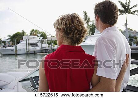 Stock Photography - Couple hugging on boat. Fotosearch