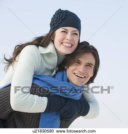 Couple in winter gear hugging View Large Photo Image Stock Image - Couple in winter gear hugging. Fotosearch