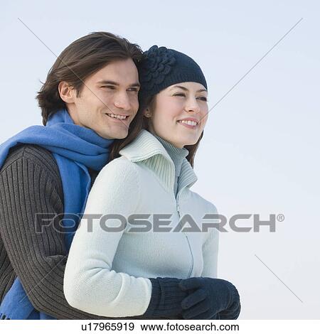 Couple in winter gear hugging View Large Photo Image Stock Photo - Couple in winter gear hugging. Fotosearch