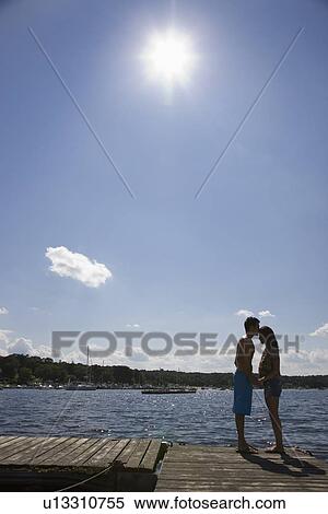 Couple kissing on dock View Large Photo Image Stock Photography - Couple kissing on dock. Fotosearch