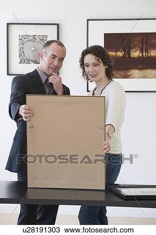 Couple looking at art in art gallery View Large Photo Image Stock Image - Couple looking at art in art gallery. Fotosearch