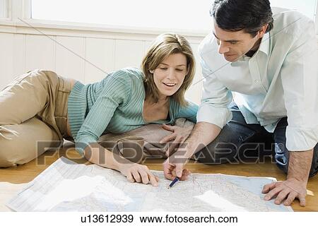 Couple looking at blueprints View Large Photo Image Stock Photo - Couple looking at blueprints. Fotosearch