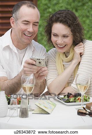 Stock Image - Couple looking at digital camera. Fotosearch