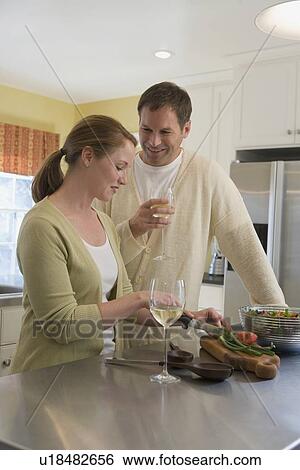 Couple making dinner in kitchen View Large Photo Image Stock Photograph - Couple making dinner in kitchen. Fotosearch