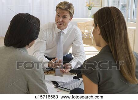 Couple meeting with financial advisor View Large Photo Image Stock Image - Couple meeting with financial advisor. Fotosearch
