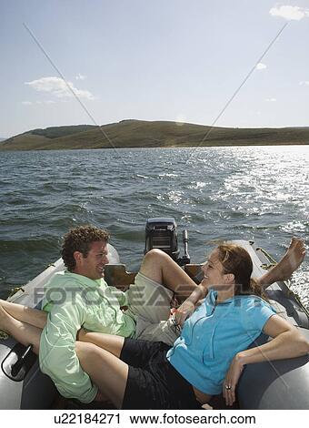 Stock Image - Couple on motorboat, Utah, United States. Fotosearch