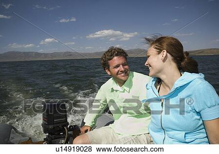 Stock Photo - Couple on motorboat, Utah, United States. Fotosearch