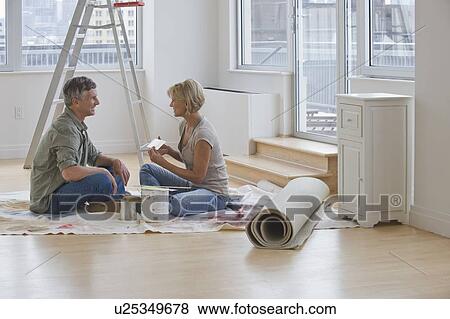 Stock Photo - Couple painting room. Fotosearch