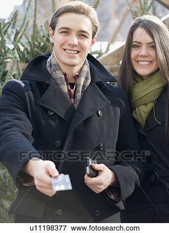 Couple paying with credit card View Large Photo Image Stock Photo - Couple paying with credit card. Fotosearch