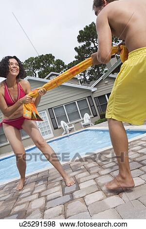 Couple playing tug-of-war with towel View Large Photo Image Stock Photo - Couple playing tug-of-war with towel. Fotosearch