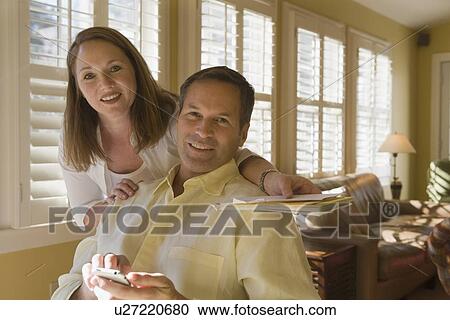 Couple posing in livingroom View Large Photo Image Stock Image - Couple posing in livingroom. Fotosearch