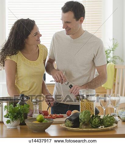 Couple preparing meal in kitchen View Large Photo Image Stock Photo - Couple preparing meal in kitchen. Fotosearch