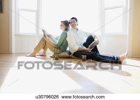 Stock Photograph - Couple reading back to back. Fotosearch