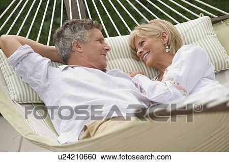 Couple relaxing in hammock View Large Photo Image Stock Image - Couple relaxing in hammock. Fotosearch
