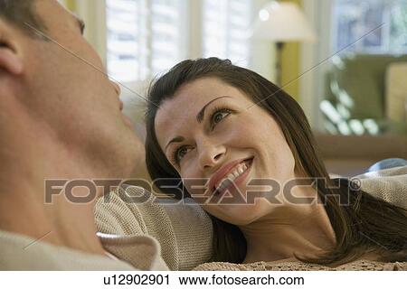 Couple relaxing in livingroom View Large Photo Image Stock Image - Couple relaxing in livingroom. Fotosearch