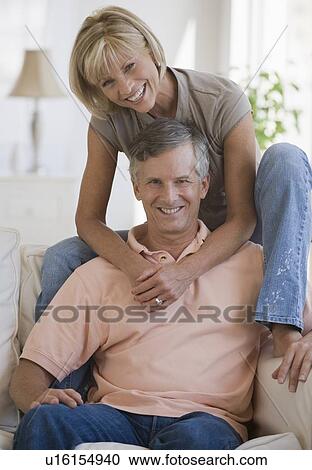 Couple relaxing in livingroom View Large Photo Image Stock Image - Couple relaxing in livingroom. Fotosearch