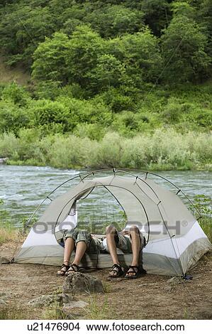 Couple relaxing in tent View Large Photo Image Picture - Couple relaxing in tent. Fotosearch