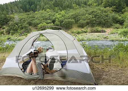 Stock Photo - Couple relaxing in tent. Fotosearch