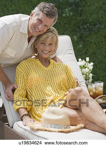 Couple relaxing on patio View Large Photo Image Picture - Couple relaxing on patio. Fotosearch