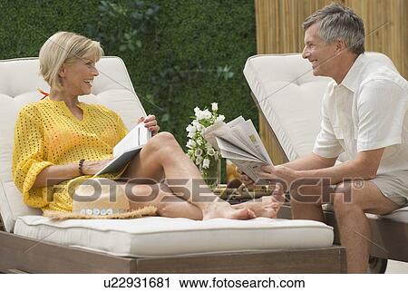 Couple relaxing on patio View Large Photo Image Stock Image - Couple relaxing on patio. Fotosearch