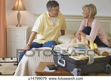 Couple resting on hotel bed View Large Photo Image Stock Photo - Couple resting on hotel bed. Fotosearch