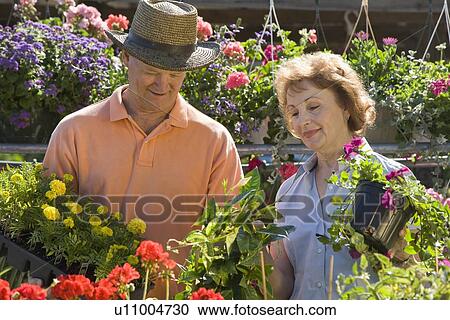 Stock Image - Couple shopping for flowers. Fotosearch