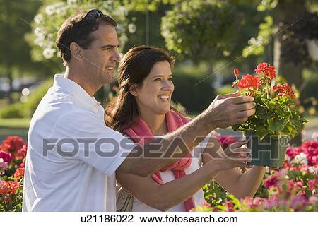 Stock Image - Couple shopping for flowers. Fotosearch