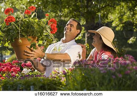 Stock Photo - Couple shopping for flowers. Fotosearch