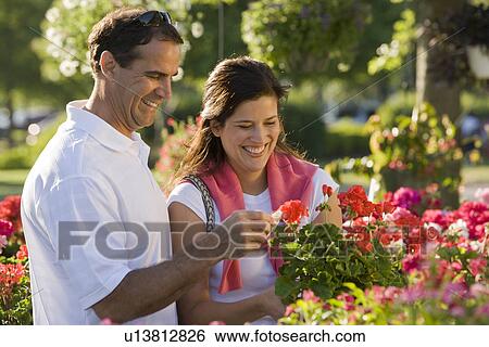 Stock Photograph - Couple shopping for flowers. Fotosearch