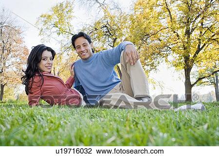 Couple sitting in grass View Large Photo Image Stock Image - Couple sitting in grass. Fotosearch
