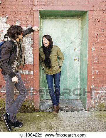 Couple talking in urban doorway View Large Photo Image Stock Photography - Couple talking in urban doorway. Fotosearch