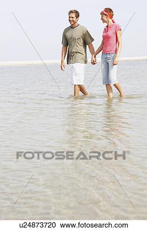 Couple wading in ocean View Large Photo Image Stock Image - Couple wading in ocean. Fotosearch